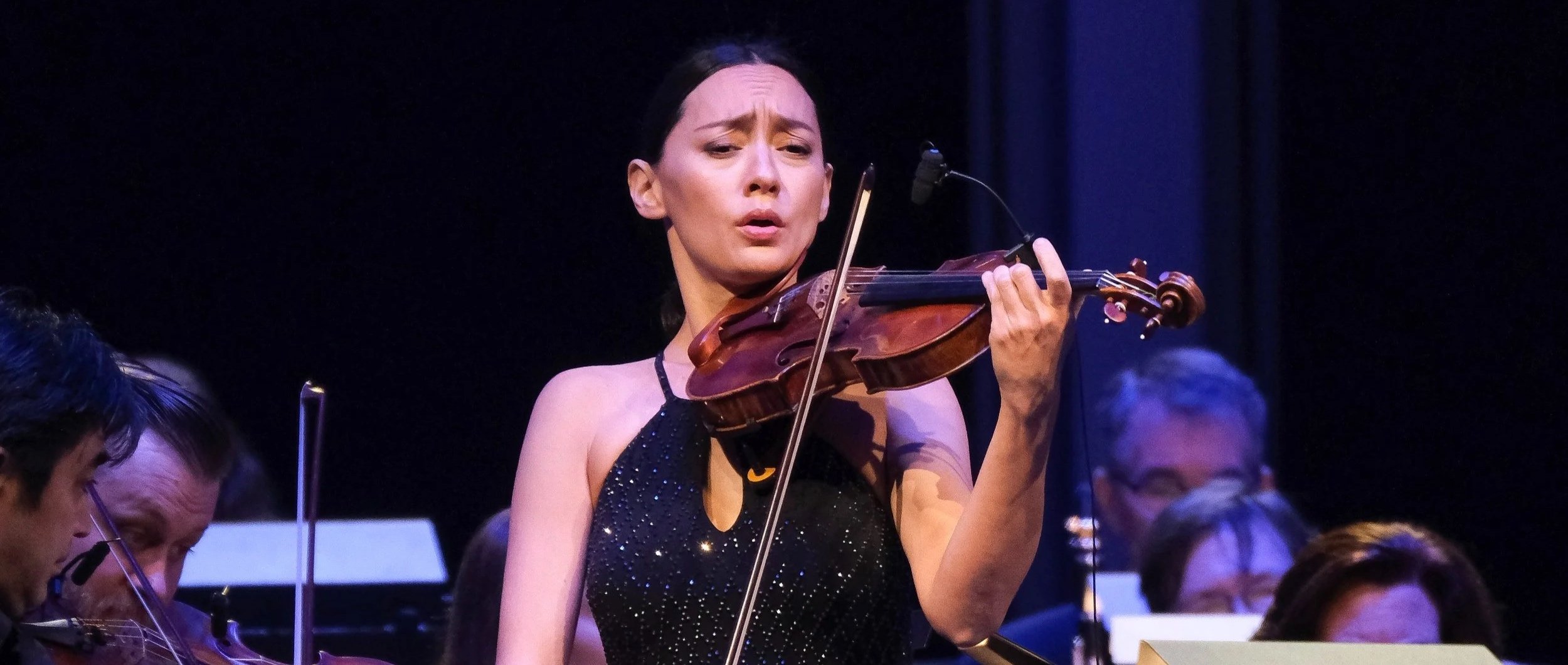 Lucia Micarelli performing live on stage with violin